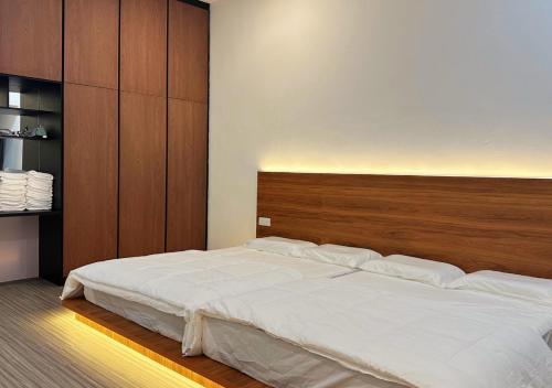 a bedroom with a large bed with a wooden headboard at The Luxurious 23, GameTopia Villa in Johor Bahru