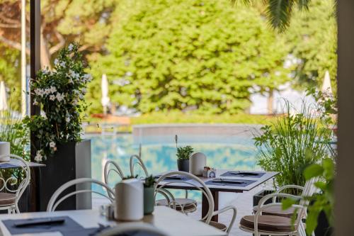 a row of tables and chairs on a patio at Hotel San Marco in Bardolino