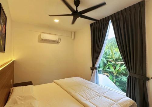 a bedroom with a ceiling fan and a window at The Luxurious 23, GameTopia Villa in Johor Bahru