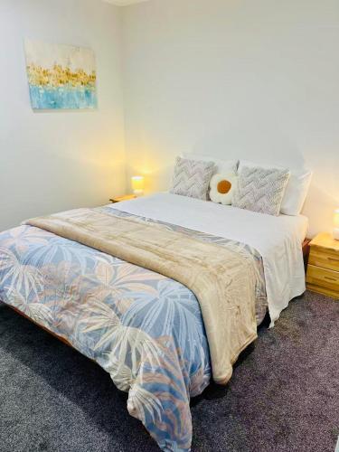 a bedroom with a large bed with a pillow at Handy Riccarton New Home Walk to Westfield, Tower Junction & Close to Hagley Park in Christchurch