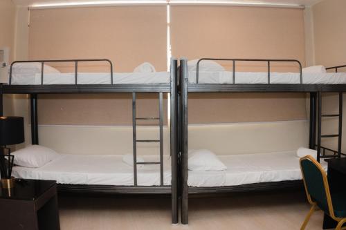 a dorm room with two bunk beds in it at The New View by Ecotel - Cebu in Cebu City