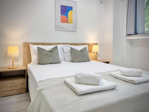 a bedroom with a large white bed with two pillows at Hello Studios Budget Stays Free Parking & Wifi in Stara Zagora