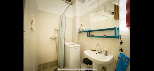 a bathroom with a sink and a toilet and a shower at Best Location cosy Art flat in Budapest