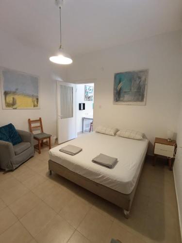 a bedroom with a bed and a chair in it at My Lovely Apt in Tel Aviv
