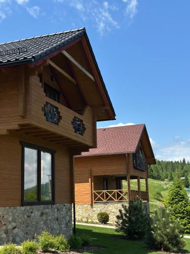 a large house with a gambrel roof at Біля Плаю in Plav'ya