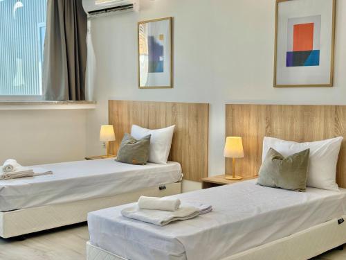 two beds sitting next to each other in a room at Hello Studios Budget Stays Free Parking & Wifi in Stara Zagora
