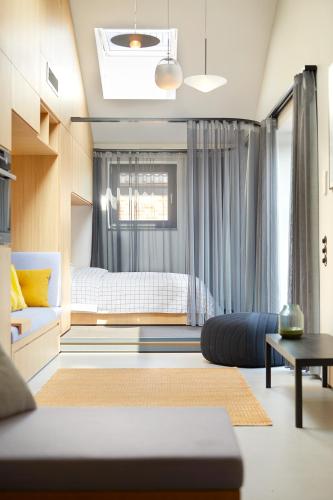 a bedroom with a bed and a window with curtains at Lighthouse Hotel & Spa in Büsum