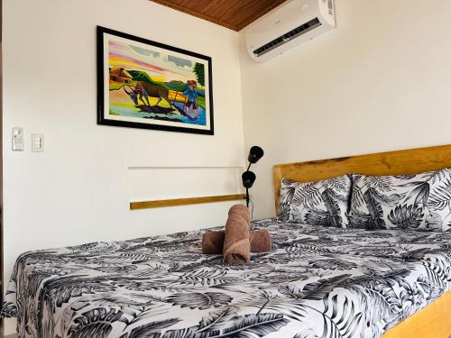 a bedroom with a bed with a teddy bear on it at ThePureYann in San Juan