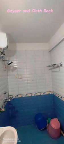 a bathroom with a swimming pool with a toilet and a sink at Marigold Bungalow in Kelavli
