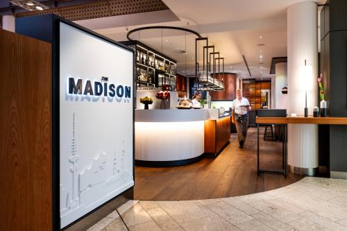 a lobby of a restaurant with a bar at THE MADISON Hotel Hamburg in Hamburg