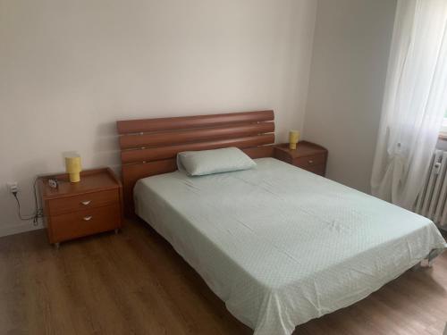 a bedroom with a bed and two night stands at Affittacamere via Moncolano mare Barcola in Trieste