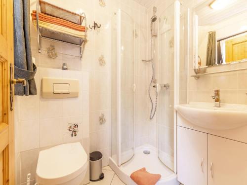 a bathroom with a shower and a toilet and a sink at Home with Garden, Hallenberg in Hallenberg