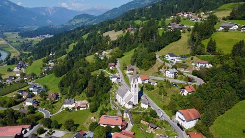 an aerial view of a small village in the mountains at Restaurant - Café - Pension HASSLER in Berg im Drautal