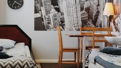 a bedroom with a table and chairs and a dining room at Hostelli Marja in Mikkeli