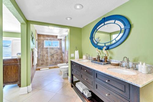 a bathroom with a sink and a mirror at Waterfront Covered alfresco lounge Heated Pool Anchor Key in Islamorada