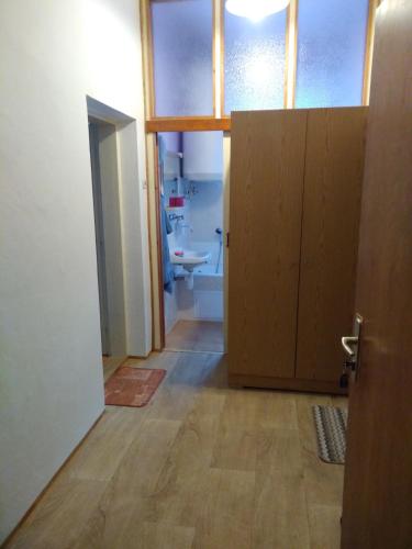 a room with a bathroom with a door and a sink at Pension V údolí v Jizerských horách in Josefuv dul