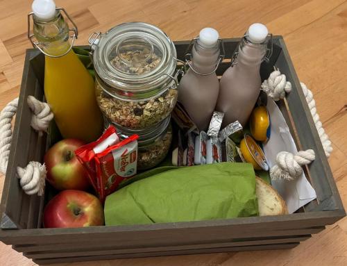 a box filled with food and drinks and apples at Apartmani DA in Piran