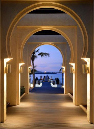 an archway to a resort with a view of the ocean at One&Only Royal Mirage Resort Dubai in Dubai