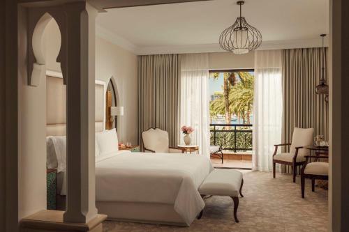 a bedroom with a bed and a living room at One&Only Royal Mirage Resort Dubai in Dubai