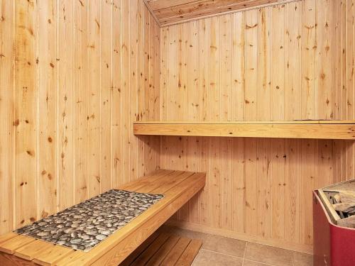 a sauna with wooden walls and a wooden shelf at 12 person holiday home in Væggerløse-By Traum in Marielyst