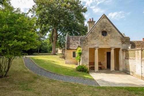 an old stone house with a walkway at The Gate House in Peterborough