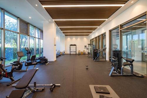a gym with several treadmills and exercise bikes at Begonia Hotel in Sanya