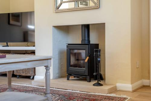 a fireplace with a stove in a living room at The Gate House in Peterborough