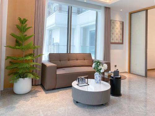 a living room with a couch and a coffee table at Begonia Hotel in Sanya