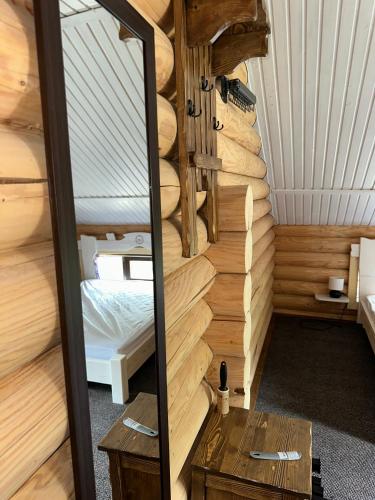 a small room with a bed and a mirror at LAVANDA hotel club in Slavske