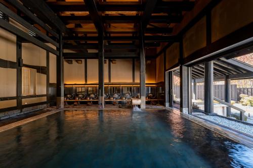 a swimming pool in a large building with windows at Hotel Sierra Resort Hakuba in Hakuba