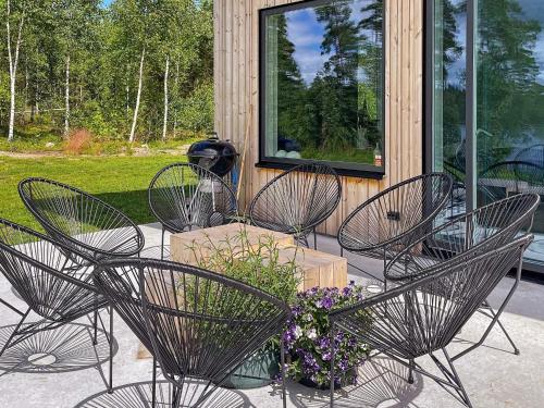 a group of chairs and flowers on a patio at 8 person holiday home in HÅCKSVIK-By Traum in Håcksvik