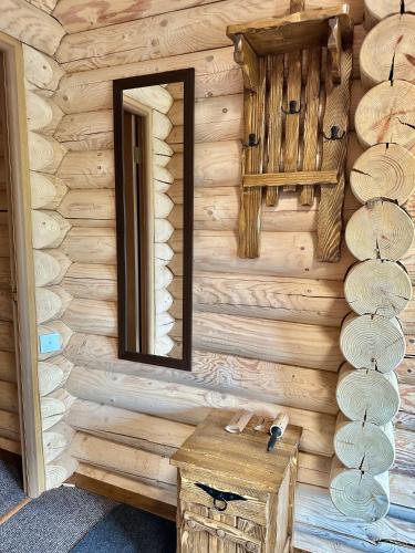 a mirror on the wall of a log cabin at LAVANDA hotel club in Slavske