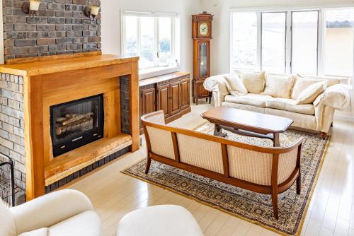 a living room with a fireplace and a couch at 鎌倉 富士山が見える絶景の館 in Kamakura