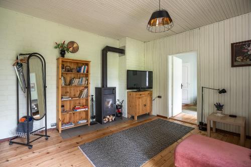a living room with a flat screen tv and a couch at Vallaku Guesthouse in Pala