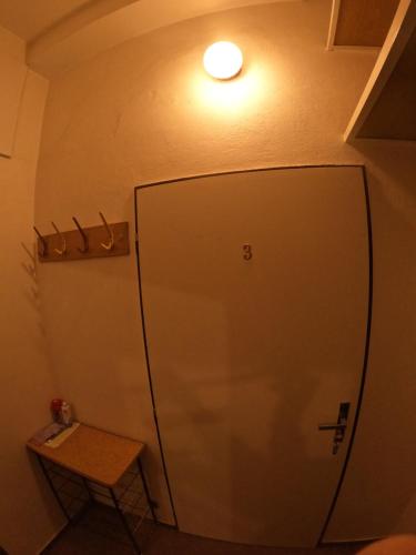 a door in the corner of a room with a table at Pension V údolí v Jizerských horách in Josefuv dul