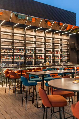 a restaurant with tables and chairs and shelves of wine bottles at BURJ ON BAY Hotel in Jounieh