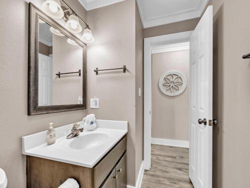 a bathroom with a sink and a mirror at Beachside Villas 122- Sun for the Roses in Santa Rosa Beach