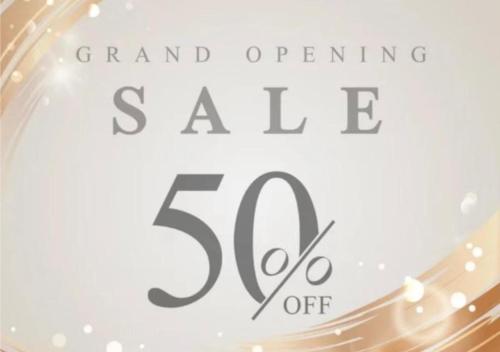 a sign that says grand opening sale off at M Candy Hotel in Melaka