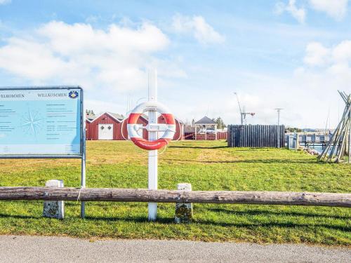 a sign sitting next to a bench in a field at 6 person holiday home in Højslev-By Traum in Højslev