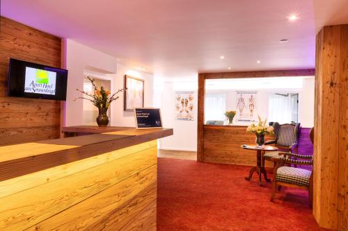 a lobby with a bar with a table and chairs at Apart Hotel am Sonnenhügel in Bad Birnbach