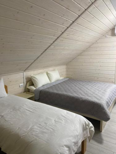 a room with two beds in a attic at Yaremchuk lodge in Tyudov