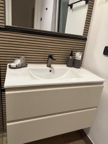 a sink in a bathroom with a mirror at B&B Bari Apartment by Margi in Bari