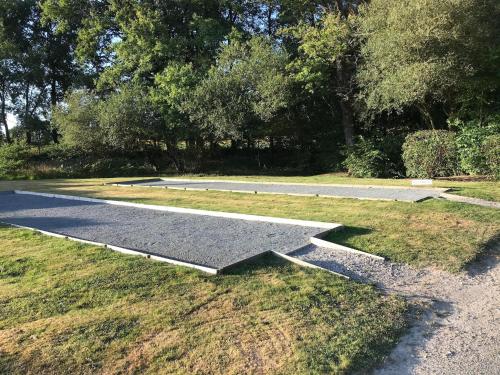 an empty pathway in a park with trees and grass at Amazing holiday home in Les Forges with terrace in Les Forges