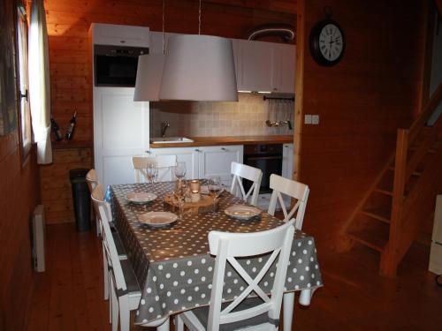 a dining room table with a polka dot table cloth at Poolside Bliss Near Lake in Beaulieu