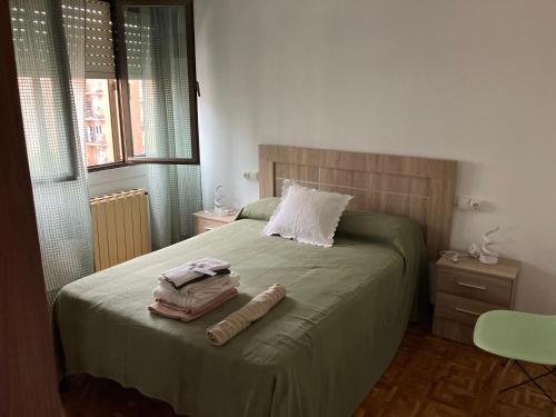 a bedroom with a bed with two towels on it at El COTO - VUT 6639 AS in Gijón
