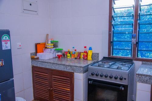 a kitchen with a stove and a counter top at Lannan Escapes in Diani Beach