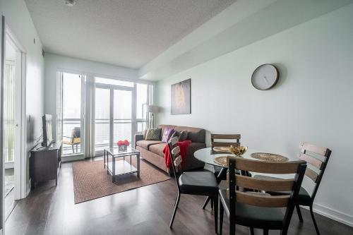 a living room with a couch and a table at Modern 1 Bedroom Dunfield Ave Apartment in Toronto