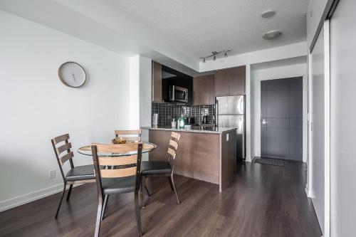 a kitchen with a table and chairs in a room at Modern 1 Bedroom Dunfield Ave Apartment in Toronto