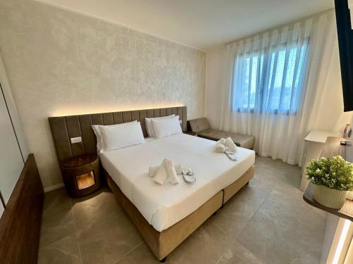 a bedroom with a large bed with towels on it at Caribe Sunset - Large 3 Bedrooms with Caribbean Pool in Lido di Jesolo