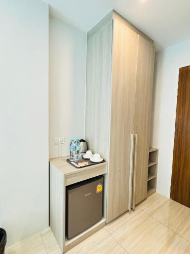 a small kitchen with a counter and a cupboard at Icon Dome Bangkok in Bangkok